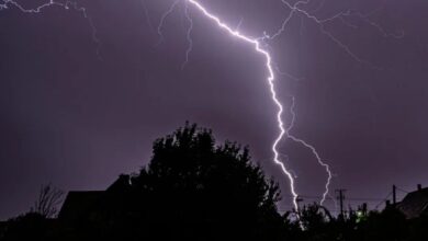 A conceptual image showing dark clouds, lightning, and rain over a city skyline in Chhattisgarh, representing the latest weather update and 5-day alert.