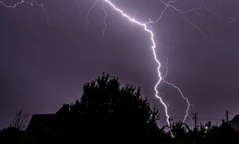 A conceptual image showing dark clouds, lightning, and rain over a city skyline in Chhattisgarh, representing the latest weather update and 5-day alert.