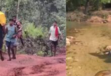 A conceptual image highlighting the Narayanpur Village Crisis, showing villagers carrying a sick patient on their shoulders through a rough, unpaved mountainous terrain in Chhattisgarh.