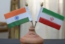 A conceptual image showing the flags of India and Iran with a reassuring handshake, amidst a backdrop of the ongoing Middle East conflict and the US-Iran War.