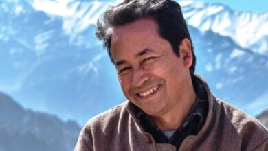 Smiling man with snowy mountains backdrop